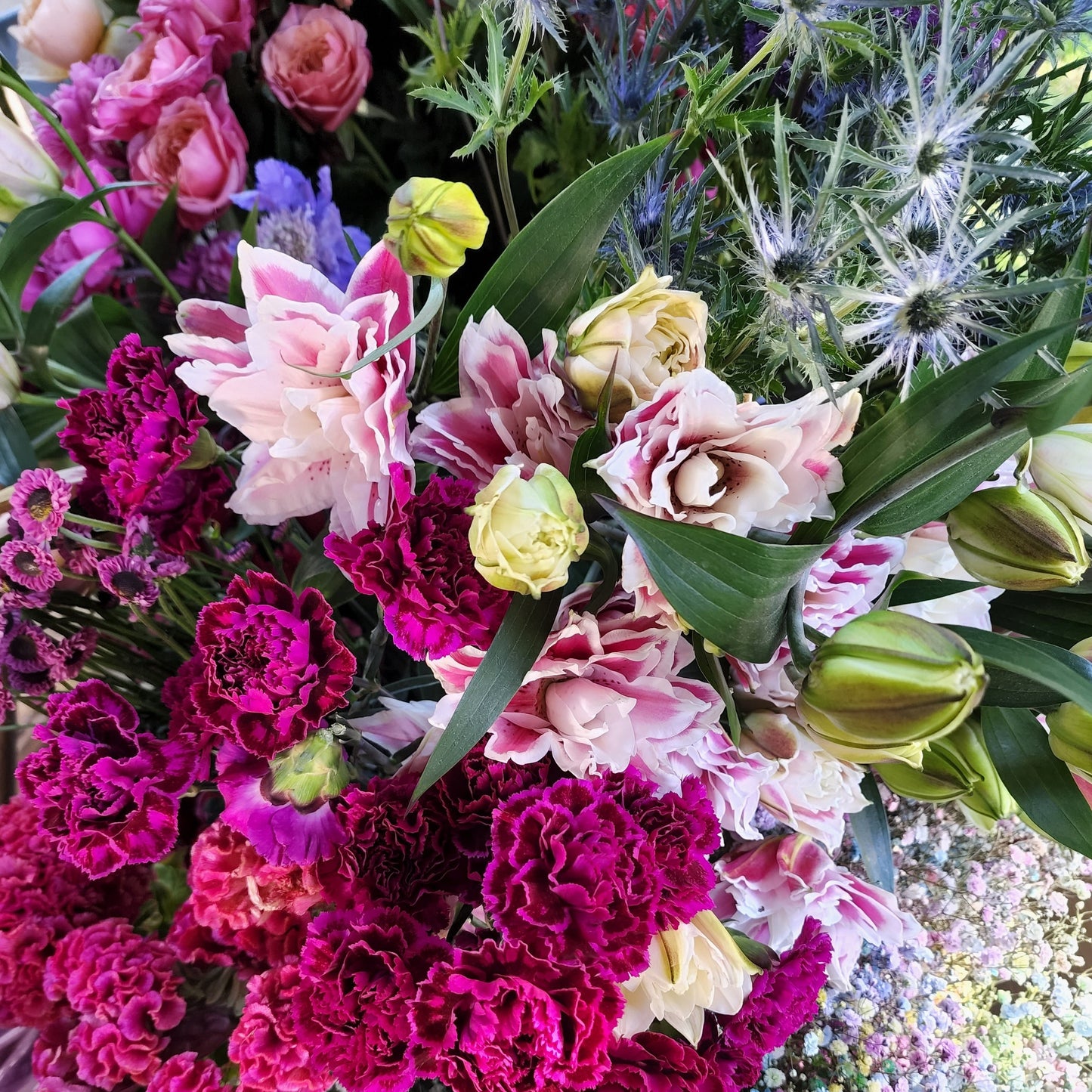 Bright, seasonal fresh flower bouquet in pinks, fuchsias, and blues 